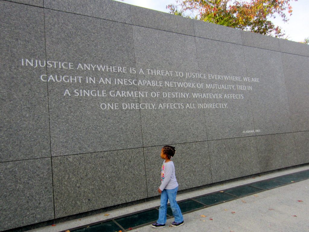 Girl looking up at Martin Luther King Jr. memorial