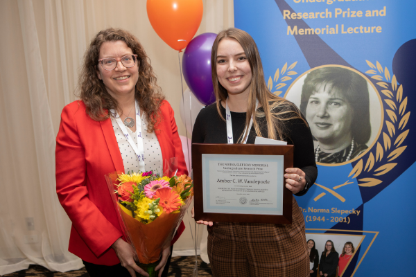 Dr. Heather Coleman (left) presenting the Norma Slepecky Undergraduate Research Prize to Amber Vandepoele (right)