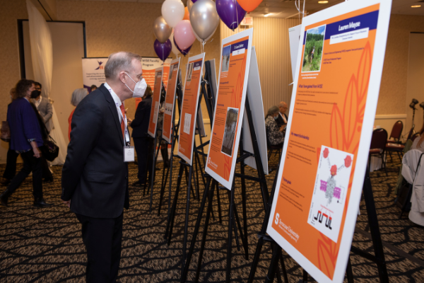 Chancellor Kent Syverud reading the posters featuring members of the WiSE community